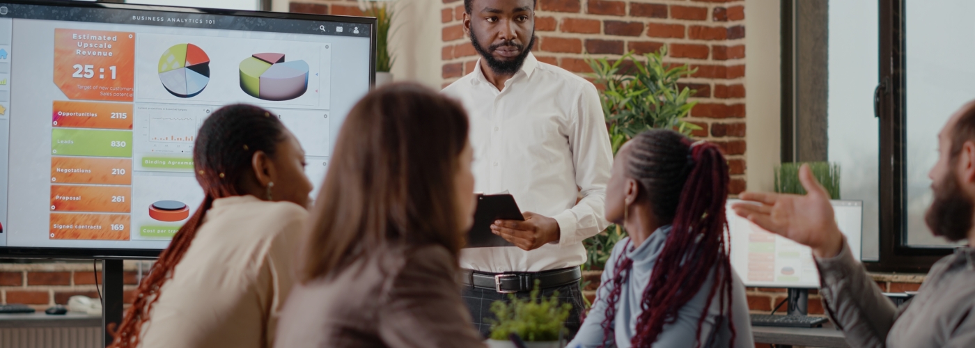 Company employee explaining charts presentation on monitor Company employee explaining charts presentation on monitor to plan project for financial development and growth. Business man meeting with colleagues to work on marketing strategy.